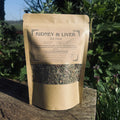 Kraft paper packaging of 'Kidney & Liver Detox' tea on a wooden surface with greenery in the background