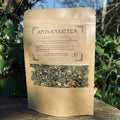 Tea package labeled 'Anti-Anxietea' on a wooden surface with a natural background