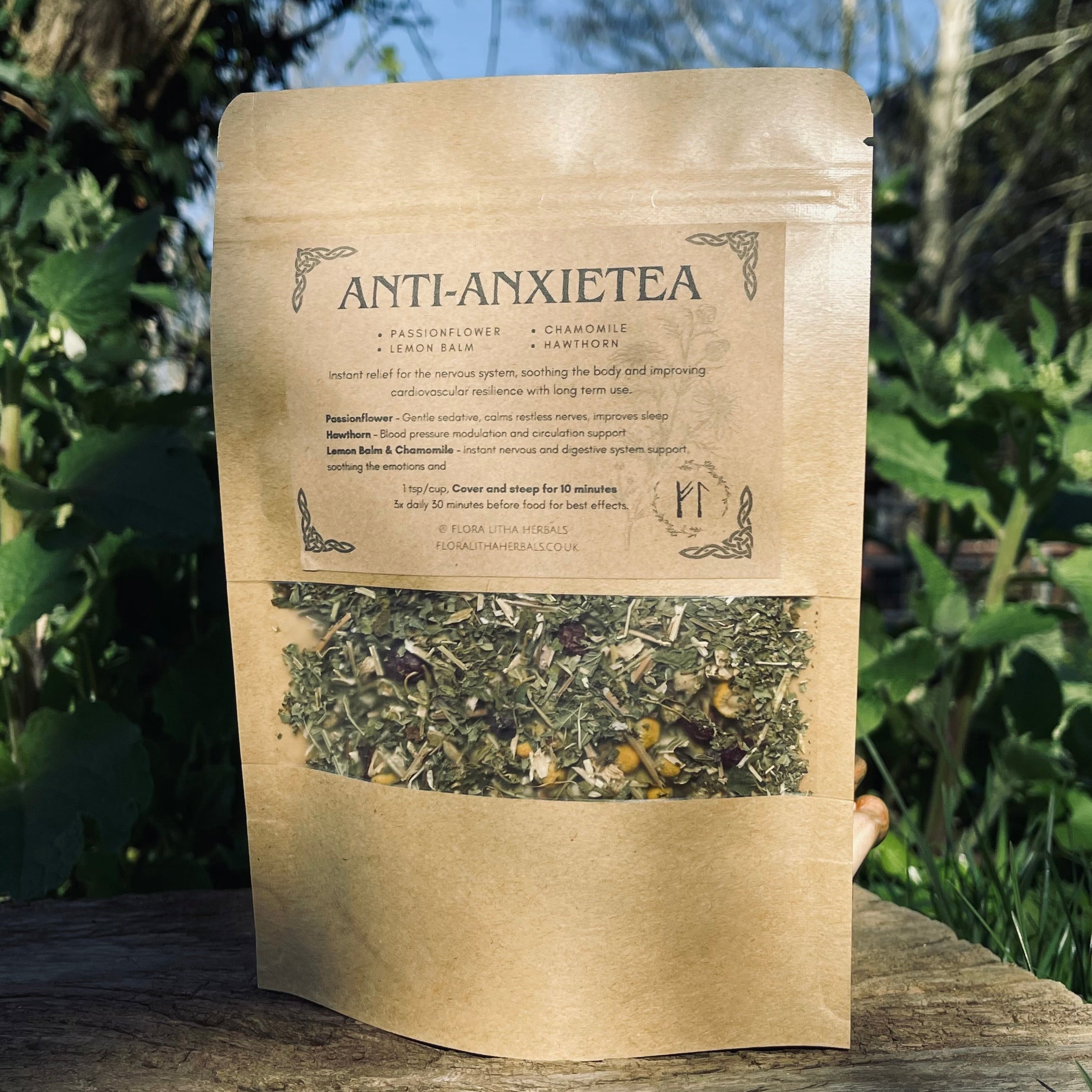 Tea package labeled 'Anti-Anxietea' on a wooden surface with a natural background
